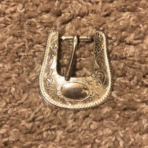 Silver belt buckle.